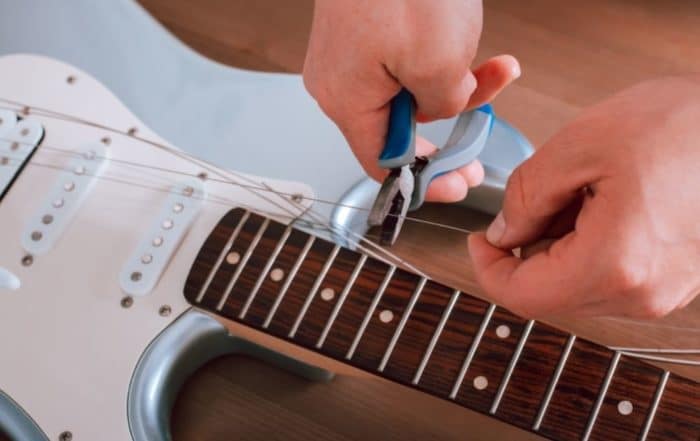 How Much Does It Cost To Restring A Guitar (What You Need To Know)