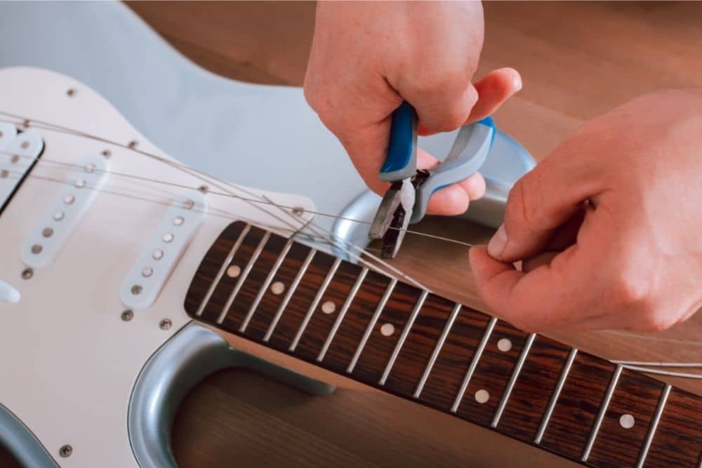 How Much Does It Cost To Restring A Guitar (What You Need To Know)