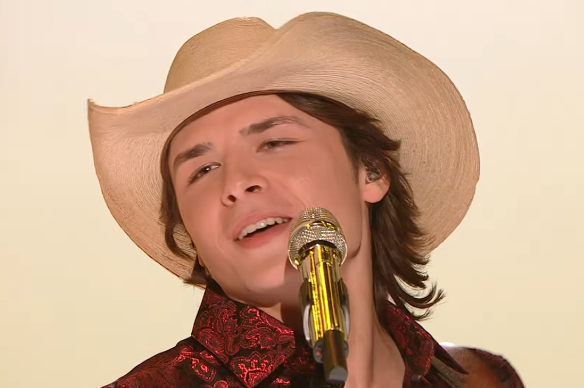 John Foster singing into microphone