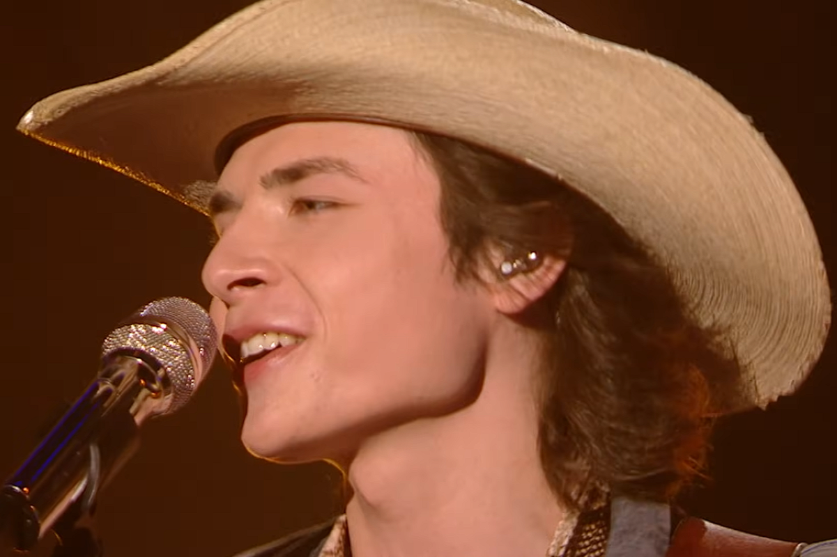 John Foster singing into microphone