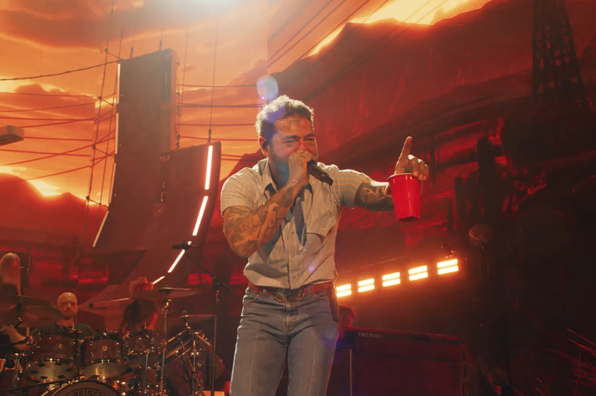 Post Malone singing into microphone