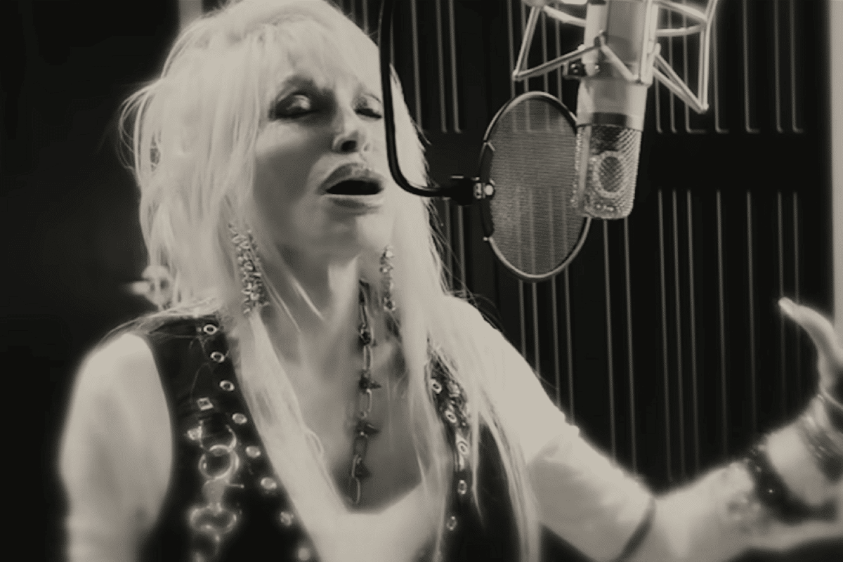 Dolly Parton singing into microphone
