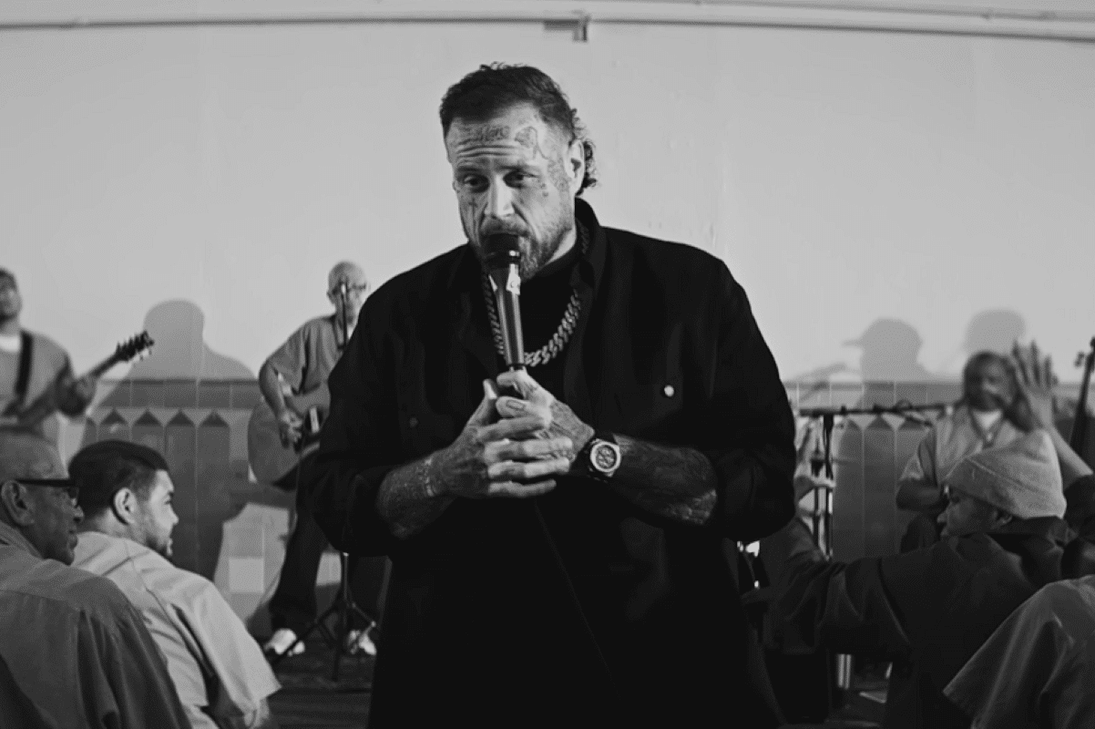 Jelly Roll singing into microphone at San Quentin