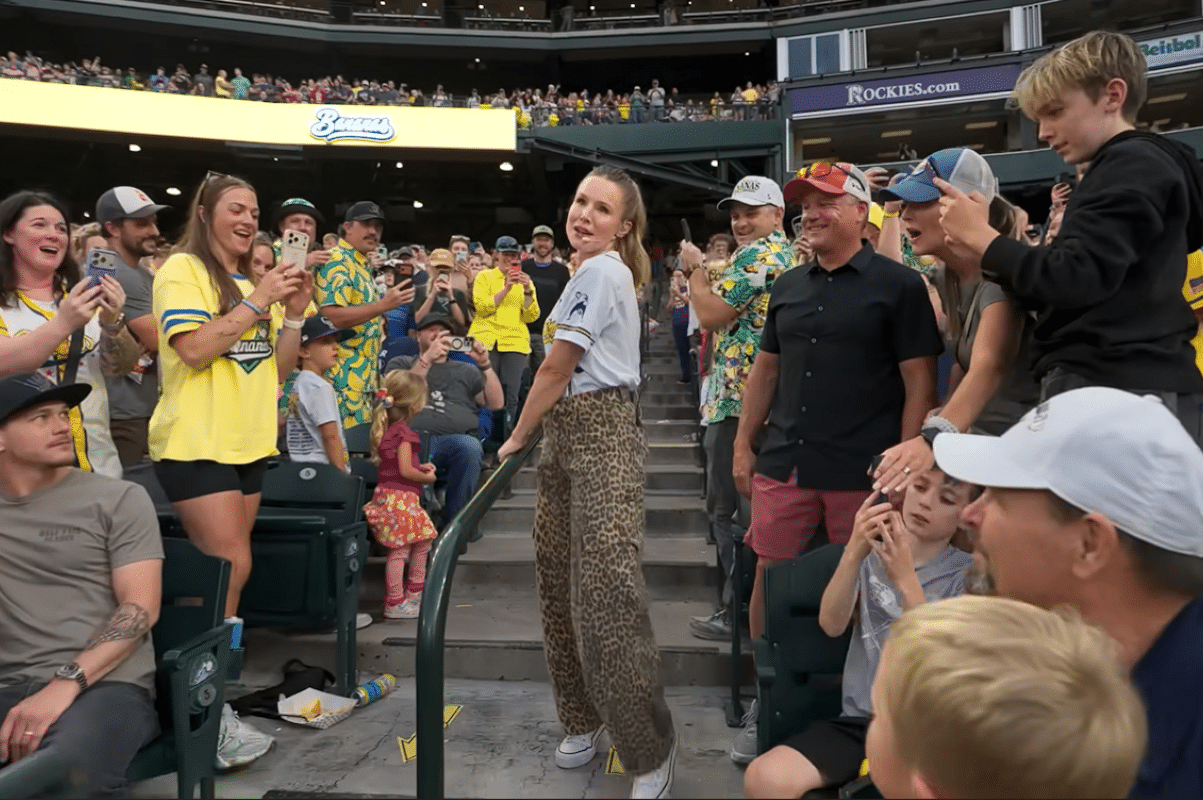 Kristen Bell singing in the stands of a Savannah Bananas game