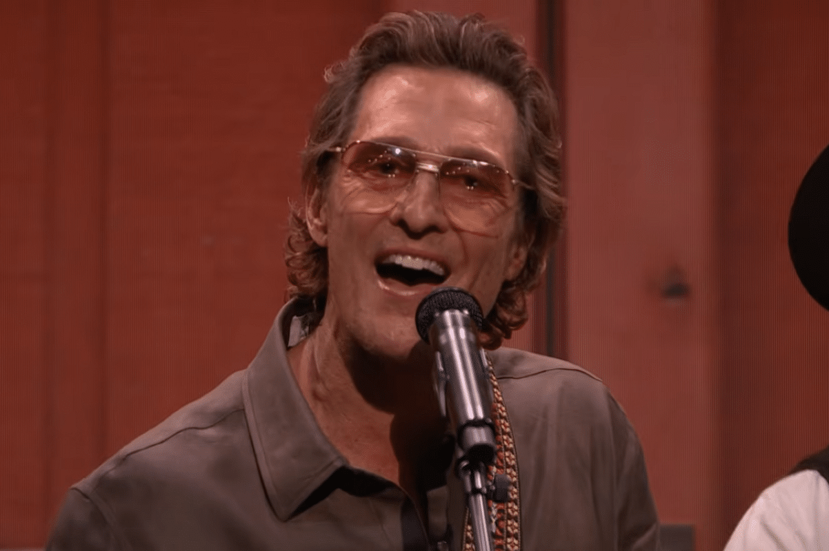 Matthew McConaughey singing into microphone